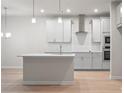 Modern kitchen with island, stainless steel appliances, and light gray cabinets at 1032 Rose Dr, Marietta, GA 30060