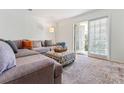 Spacious living room with sectional sofa and balcony access at 1150 Collier Nw Rd # J15, Atlanta, GA 30318