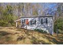 Side view of a gray house with red door and landscaping at 2329 Abner Nw Pl, Atlanta, GA 30318