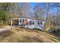 Ranch style house with red door and carport at 2329 Abner Nw Pl, Atlanta, GA 30318