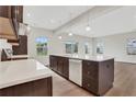 Spacious kitchen with island, white countertops, and dark brown cabinets at 1601 Fuma Leaf Way, Mcdonough, GA 30253