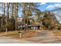 House exterior with a driveway and a large yard at 4399 Plantation Ln, Norcross, GA 30093