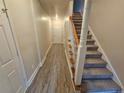 Bright hallway with stairs and vinyl flooring at 4221 Sw Notting Hill Sw Dr, Atlanta, GA 30331