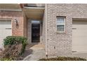 Welcoming front entrance with a black door and a charming brick facade at 2166 Waterford Park Dr, Lawrenceville, GA 30044
