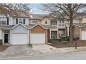 Three-unit townhouse building with attached garages and landscaping at 577 Reed Se St, Atlanta, GA 30312