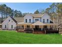 White farmhouse with large porch and lush green lawn at 3505 Moss Landing Rd, Acworth, GA 30102