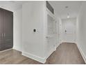 Bright hallway featuring hardwood floors, neutral walls and access to a large storage space at 1080 Peachtree Ne St # 804, Atlanta, GA 30309