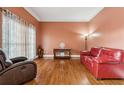 Living room with hardwood floors, fireplace, and large windows at 2035 Walnut Creek Xing, Alpharetta, GA 30005