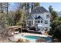 A backyard with a pool, deck, patio area and a built in swing providing a private outdoor space at 4086 Haverhill Dr, Atlanta, GA 30342