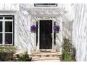 Stylish front entrance with black door, decorative plants, and a stone path leading to the entrance at 4086 Haverhill Dr, Atlanta, GA 30342