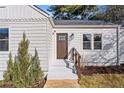 Renovated front entrance with a modern brown door and white trim at 1664 Columbia Dr, Decatur, GA 30032