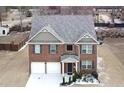 Two-story brick home with a three-car garage and landscaped yard at 3573 Stonebranch Ln, Loganville, GA 30052