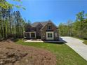 Lovely two-story brick home with a welcoming covered porch, set amidst a green lawn and a private driveway at 7449 Waterview Cv, Douglasville, GA 30135