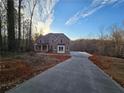 Two-story house with a long driveway leading to the front door at 7449 Waterview Cv, Douglasville, GA 30135