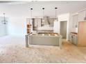 Unfinished kitchen with gray cabinets, an island, modern fixtures and plenty of natural light at 1275 Pj East Rd, Covington, GA 30014