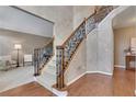 Elegant staircase with wrought iron railings and hardwood floors at 1215 Wynridge Xing, Alpharetta, GA 30005