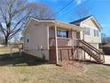 Side view of a tan house with a wooden deck and stairs at 2043 Laird Rd, Hiram, GA 30141