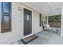 Front porch with dark door, seating, and rug at 4392 Overlook Dr, Acworth, GA 30101