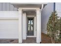 Inviting front entry with gray door and white columns at 731 Stickley Oak Way, Woodstock, GA 30189