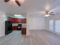 Open-concept living room and kitchen with LVP flooring at 4222 High Park Ln, Atlanta, GA 30344