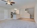 Open-concept living room with plush carpet flooring, ceiling fan and natural light at 3406 Mount Zion Rd, Stockbridge, GA 30281