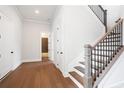 Hardwood floor hallway with doors to bedrooms and bathroom at 89 Batten Board Way, Woodstock, GA 30189