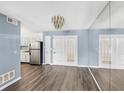 Bright dining room with wood-look floors and mirrored wall at 1016 Old Holcomb Bridge Rd, Roswell, GA 30076