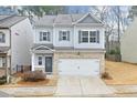 Two-story house with gray siding, brick accents, and a two-car garage at 236 Hickory Commons Way, Canton, GA 30115