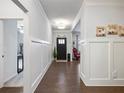 Hardwood floor entryway with wainscoting and black door at 3578 Crayton Glen Way, Buford, GA 30519