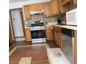 Kitchen features wood cabinets, stainless steel appliances, and tile flooring at 4053 Chapel Mill Bnd, Decatur, GA 30034