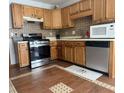 Kitchen features wood cabinets, stainless steel appliances, and tile flooring at 4053 Chapel Mill Bnd, Decatur, GA 30034