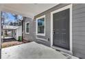Close-up of the front door with gray siding and white trim, accentuating the home's curb appeal at 1271 Lorenzo Sw Dr, Atlanta, GA 30310
