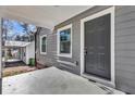 Inviting front porch with gray door and white trim at 1271 Lorenzo Sw Dr, Atlanta, GA 30310