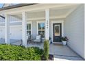 Inviting front porch with white columns, comfortable seating, and potted plants at 2044 Garvin Rd, Acworth, GA 30101