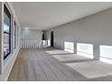 Spacious living room with neutral carpeting and large windows at 2395 River Run Dr, Douglasville, GA 30135