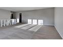 Bright living room featuring neutral walls and carpeting at 2395 River Run Dr, Douglasville, GA 30135