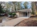 A view of the home's carport and driveway with mature trees at 3418 Longleaf Dr, Decatur, GA 30032