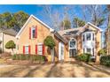 Brick house with red shutters, landscaping, and a double door entry at 7434 Woodruff Way, Stone Mountain, GA 30087