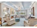 Bright living room with fireplace, chandelier, and lots of comfortable seating at 1800 Clairmont Lk # 413, Decatur, GA 30033