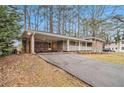 Brick ranch home with carport and a well-maintained lawn at 2791 Ponderosa Cir, Decatur, GA 30033