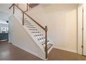 Elegant staircase with wood railings and hardwood floors at 413 Delancy Dr, Woodstock, GA 30189