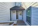 Front entrance with white door and sidelights, leading to a small wooden deck at 4485 Spring Valley Pkwy, Atlanta, GA 30349