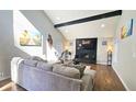 Open living area with vaulted ceiling, a modern fireplace, and a large sectional sofa at 4485 Spring Valley Pkwy, Atlanta, GA 30349
