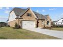 Two-story house with a large backyard and attached three-car garage at 2615 Yellowstone Farm Dr, Cumming, GA 30028