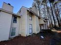 Tan colored siding townhouse with wooded backdrop at 4411 Idlewood Ln, Tucker, GA 30084