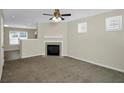 Cozy living room with fireplace and plush carpeting, bathed in natural light at 5140 Sky Ridge Way, Cumming, GA 30041