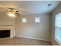 Inviting living area featuring a fireplace, neutral tones, and ample natural light at 5140 Sky Ridge Way, Cumming, GA 30041