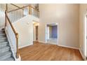 Hardwood floor entryway with staircase and view to living room at 643 Rangeley Meadows Ct, Hampton, GA 30228