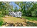 Side view of a white house with a spacious backyard at 1836 Meadow Ln, Decatur, GA 30032