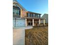 Two-story home with brick and siding, a front porch, and a landscaped yard at 221 Overlook Rd, Covington, GA 30014